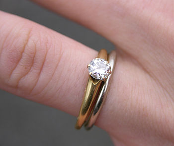A White gold wedding ring and a single diamond...